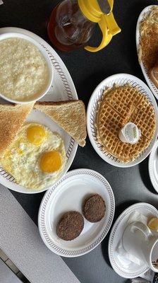 Waffle, Grits, Sunny-side eggs, Sausage and Toast.