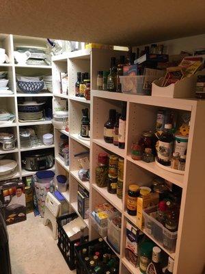 Small storage area underneath stairs turned into a spacious pantry!