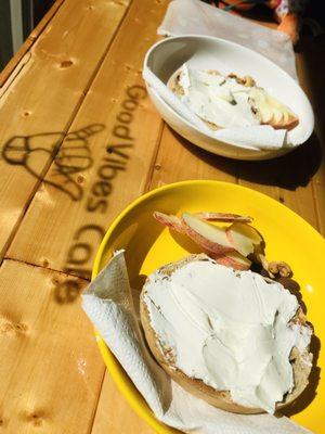 Raisin Bagel with Cream Cheese, side of fruit and nuts.