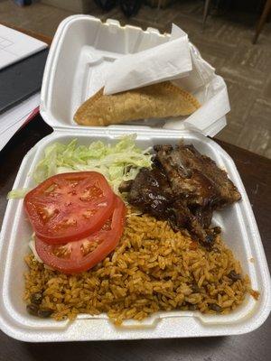 Ribs with yellow rice and a chicken pastellio