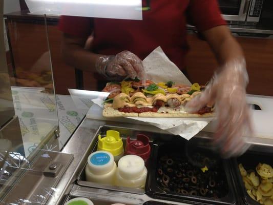 that's flat bread, meat balls,pepper jack cheese, spinach, olives, onion, roasted twice, chipotle and spicy mustard sauce.