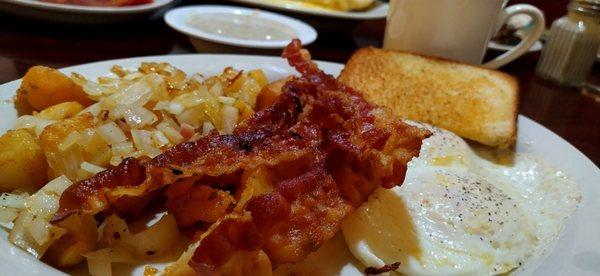 Bacon, toast & gravy, home fries with onion, eggs over medium