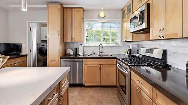 Honey Shaker Cabinets with Wild Rice Caesarstone Quartz Countertops and Dreamy Carrara Caesarstone Island Quartz Countertops.