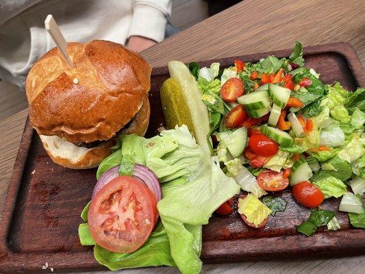 Burger with side salad. Burger is handmade patty with brioche bun. salad is fresh and delicious!