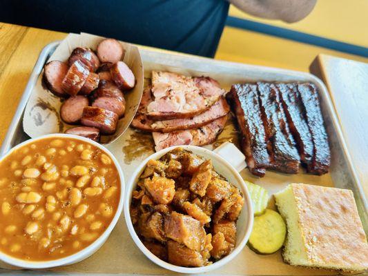 2 Smoked meats and 2 sides with Corn bread Backed Beans, sweet potatoes, smoked sugar, smoked ham and ribs