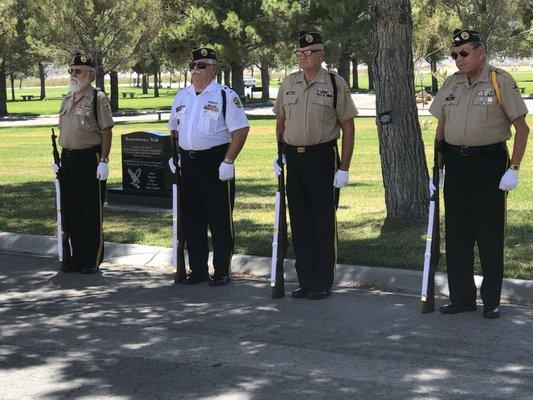 Local VFW members standing at attention awaiting the time to give the gun salute at the burial of a service member.