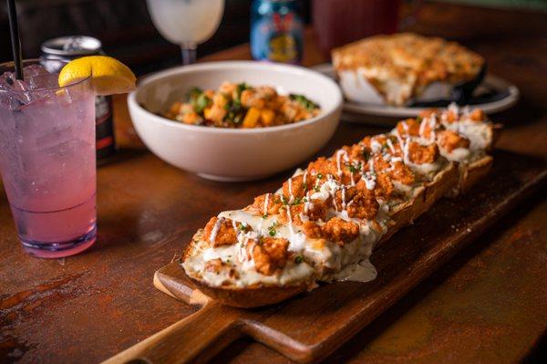 Buffalo Chicken & Blue Cheese Flatbread: With blue cheese dressing, mozzarella, and fried chicken tossed in buffalo sauce & roasted garlic.