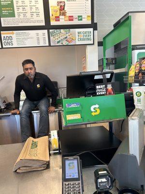 Store employee just sitting on counter where they prepare food!