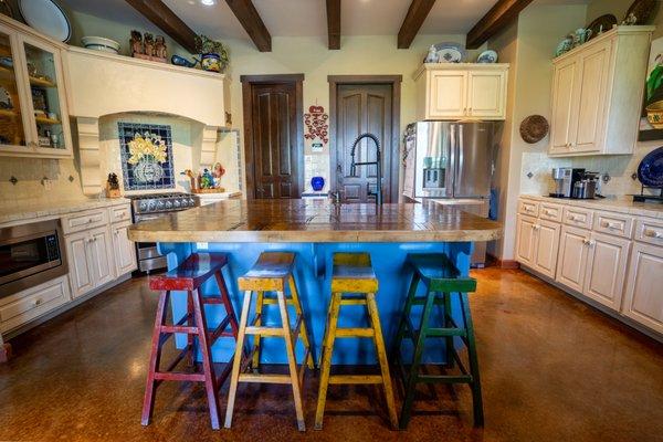 Custom Kitchen that used antique restored rail road boxcar floor as the island countertop