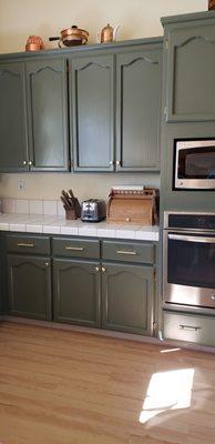 Finished painted cabinets in dark green