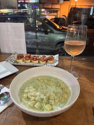 Gnocchi in pesto cream sauce, bruschetta, and rosato.