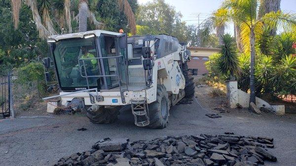 This machine grinds up your old asphalt and mixes up the dirt and blends a class 2 base