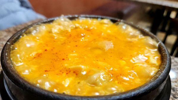 Bubbling cauldron of tofu stew with mandu