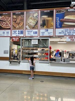 Hungry girl waiting for her chicken bake... or maybe she's eyeing the churro.