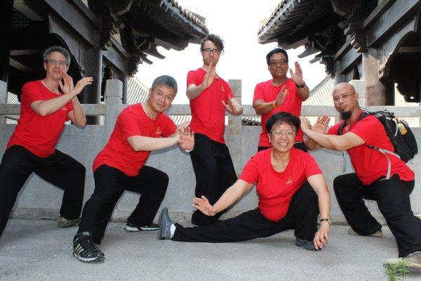 School members were posting a Taichi movement at Chen village, China.