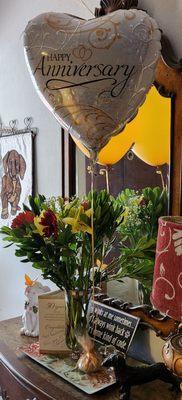 Card, flowers, and balloons on our table when we arrived.