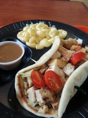 Thai chicken wrap with dressing on side and mac and cheese