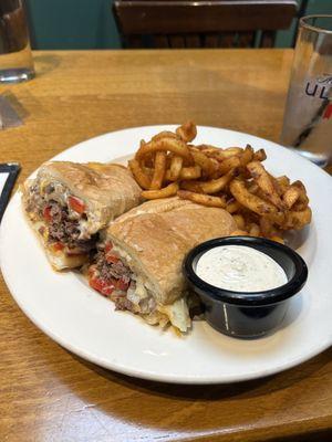 Steak and cheese sandwhich with curly fries