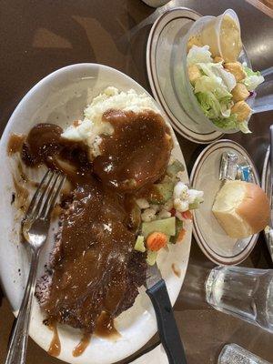 Hamburger steak with gravy and mash, comes with salad and roll.