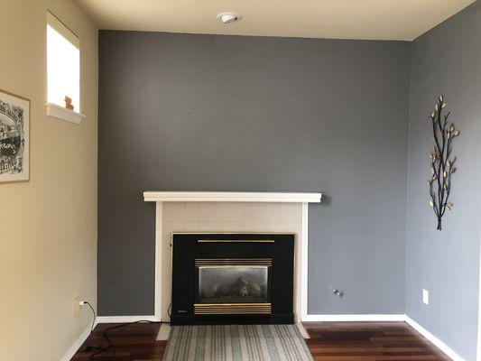 Old fireplace insert with wood mantle and painted walls