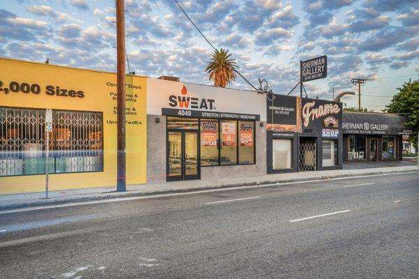 Front view of Sweat Pilates at 4049 Lincoln Blvd. displays the hand-painted logo with the tagline "Stretch | Strength | Rebound."