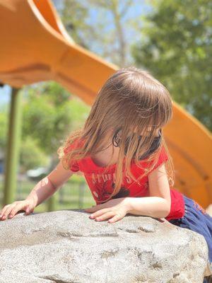 My daughter climbing their big rock!