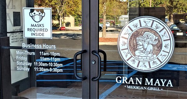 These are the hours and logo on the door to the restaurant.  Photo taken October 5, 2020.