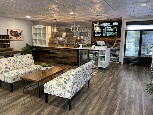 Seating area, display/ordering counter, and refrigerated baked goods.