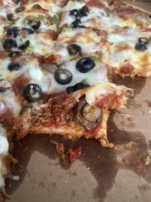 Even toppings are crammed under the other toppings & cheese!