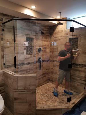 Shower door and panels being installed