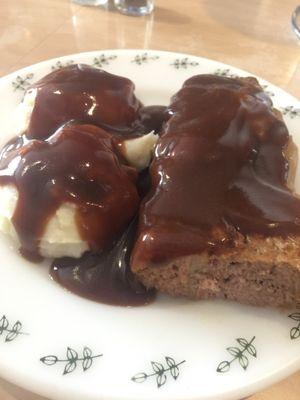 Meatloaf wrapped in cabbage with mashed potatoes and gravy. A meal for the day