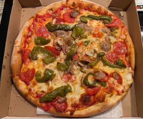 Adults pizza with sausage, pepperoni, onions and peppers