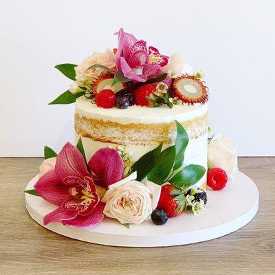 Fresh floral and fruit on a semi-naked cake