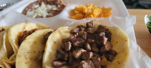 (2) Carne Asada tacos with beans and rice.