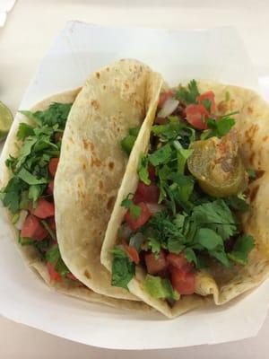 One beef and one chicken taco on flour tortilla! Yummy tex mex!