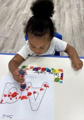 One-year-olds are developing the muscles in their hands that will eventually help them hold writing tools and control their movements better