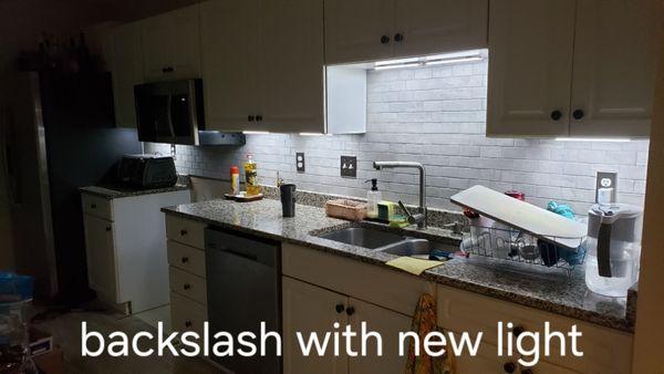 Backsplash tile installation with brand new lights under cabinets