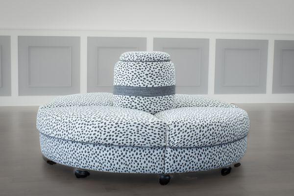 Round banquette sofa in  Dalmatian.