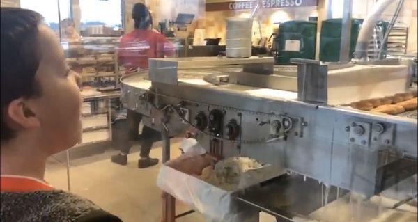 My son watching the donuts on the conveyor belt.. we love coming here!!