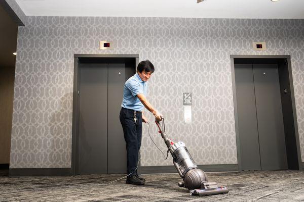 Employee Vacuuming Carpet