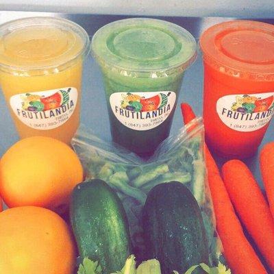 Fresh orange, green, and carrot juice