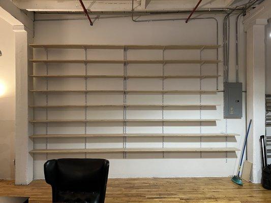 Custom industrial shelving wall for a non-profit