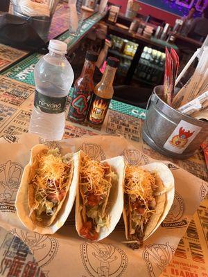 Far left is the veggie taco and the other two are the beef tacos.