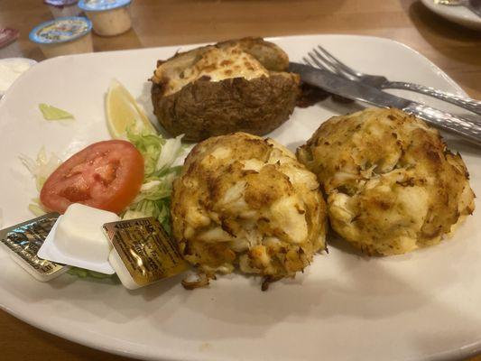 2 Crabcakes with a baked potato.