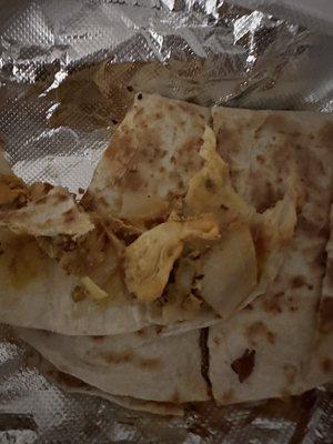 Apparently a "chicken quesadilla" - soggy tortilla, a bit of shredded chicken, and a few sad slices of onion