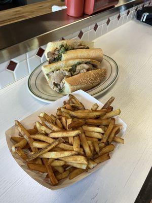 Broccoli raab, mutz, grilled pork sandwich on a long roll with fries