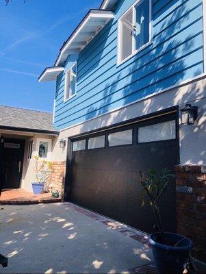 C.H.I. skyline flush black garage door with frosted windows.