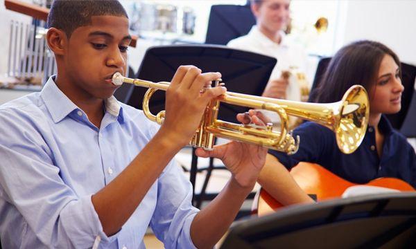 students learning how to play an instrument