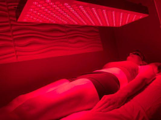 Client receiving red light therapy for beautiful skin and weight loss