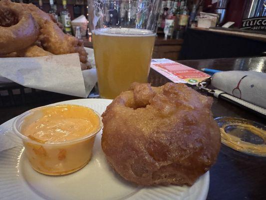 Close up of onion ring and sauce